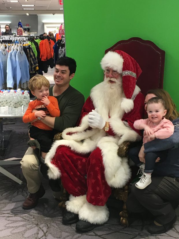 A family poses for a complimentary photo with Santa.