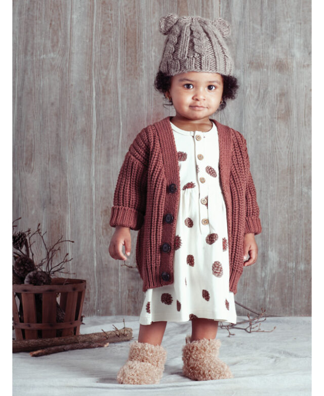Sevyn wears Huxbaby cardigan, City Mouse dress, Blueberry Hill bear hat and boots by Bearpaw.