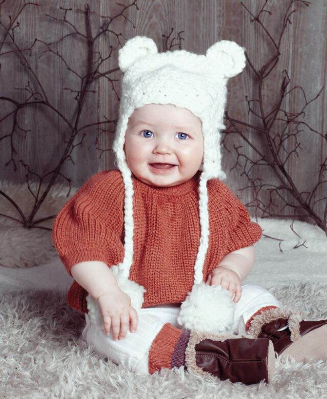Everly wears Oeuf sweater and coordinating socks, 1 + in the Family leggings, Blueberry Hill knit hat 
and soft-sole boots by Robeez.