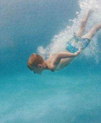 Kellen wears Boboli swim trunks.