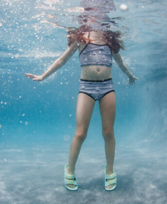 Maddie wears sailboat print two-piece by Pearl Street Swim and Joules sandals.