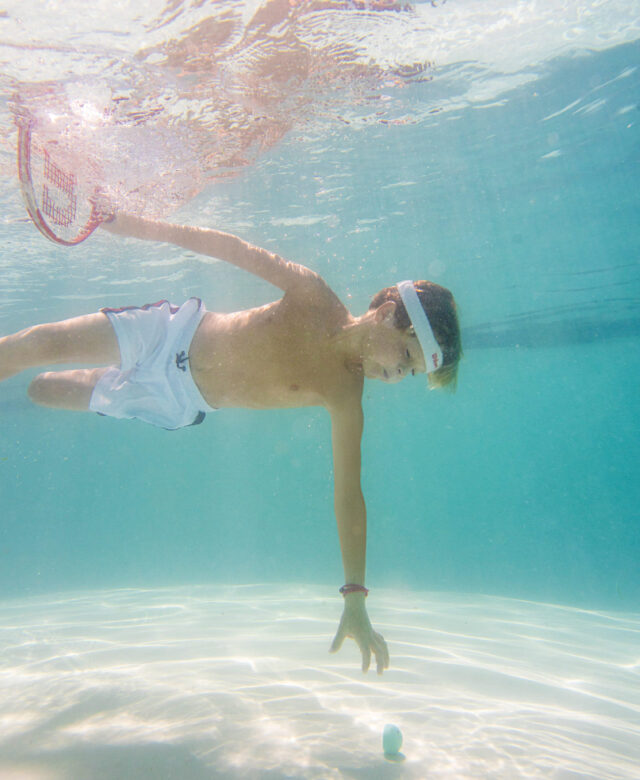 George wears Planet Sea trunks.