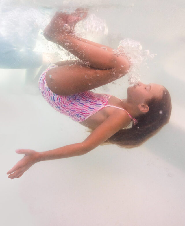 Lilly wears Toobydoo striped halter one-piece.