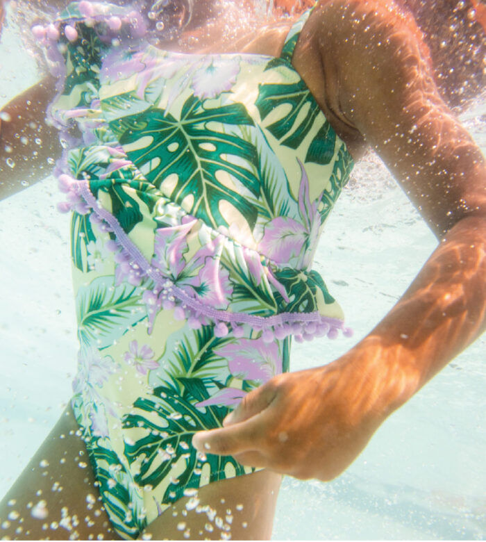 Zion wears Shade Critters tropical one-piece.
