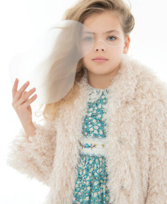 Peyton wears Lola + the Boys tie-dye faux fur coat and sequin shift dress.