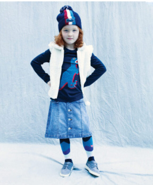 Ariana wears Mud Pie vest, Catimini tights, Paul Smith Junior hat and dinosaur shirt, Molo denim skirt, and her own shoes.