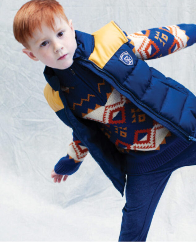 Nicholas wears 3 Pommes puffer vest and sweater with Andy & Evan pants.
