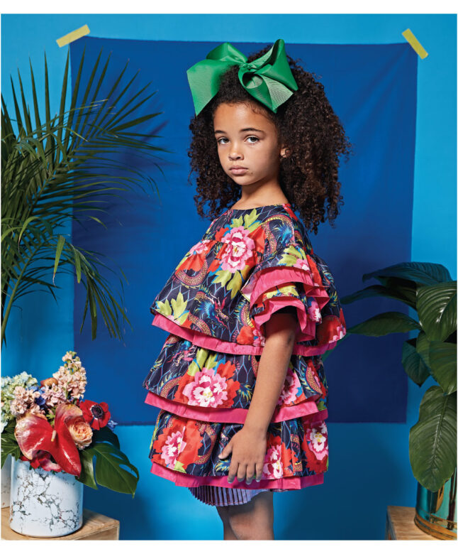 Dorran wears Kenzo metallic skirt 
under floral dress with green bow by Bows Arts.

Photographed in Los Angeles, California.