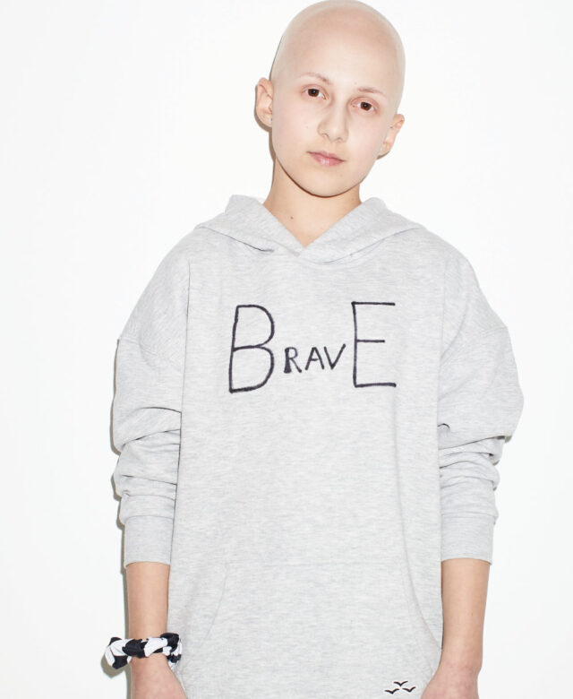 Stella wears Lazypants sweatshirt (customized with her own message) and Republic of Pigtails scrunchies (on wrist).