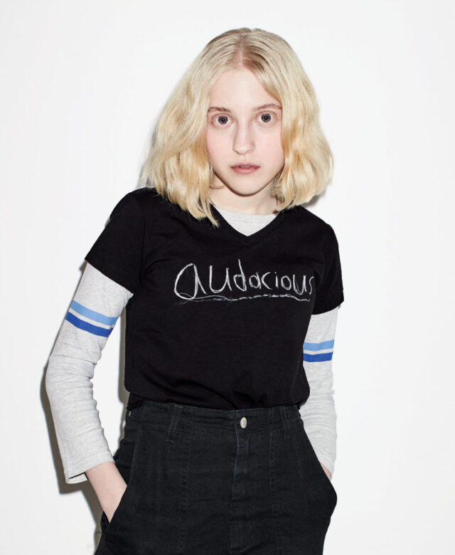 Marley wears Candy Pink 
(customized) black T-shirt over Tea Collection long-sleeved shirt 
and her own pants.