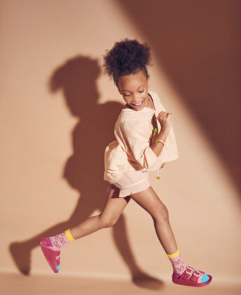 Laniya wears Chandamama blouse, Bonmot shorts, socks by Fun Socks and Joules sandals.