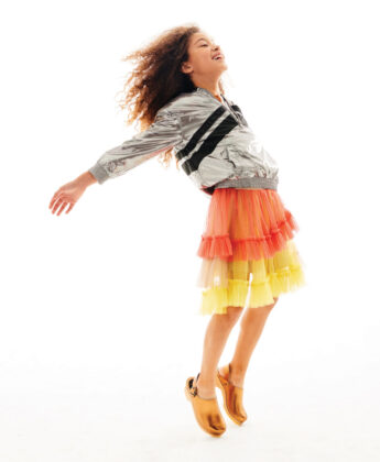 Dominique wears Givenchy anorak, Raspberry Plum skirt and Cape Clogs metallic clogs.
